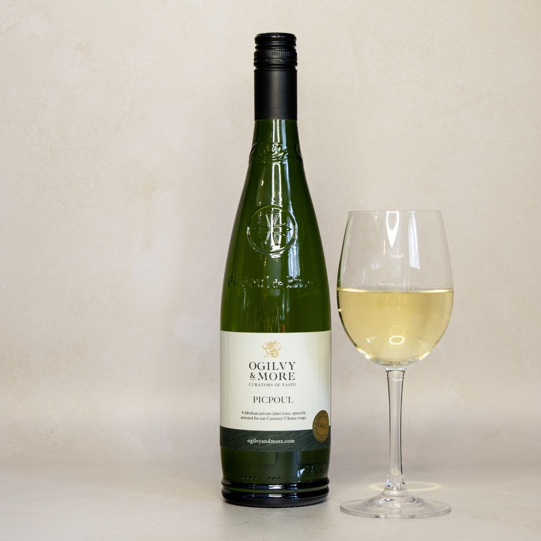 Bottle of Ogilvy & More Picpoul white wine with a glass of wine