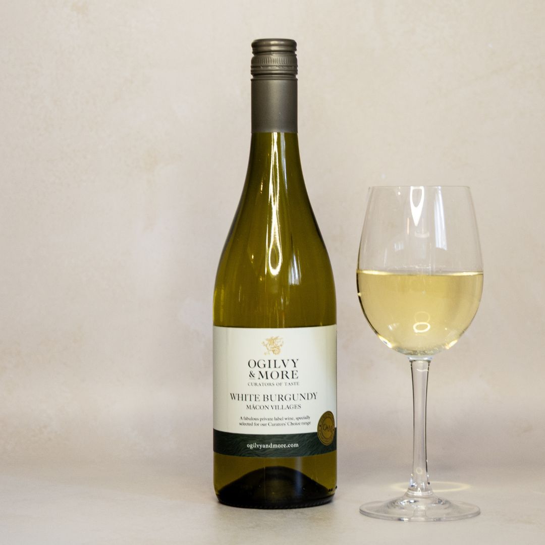 Bottle of Ogilvy & More White Burgundy wine with a glass of wine