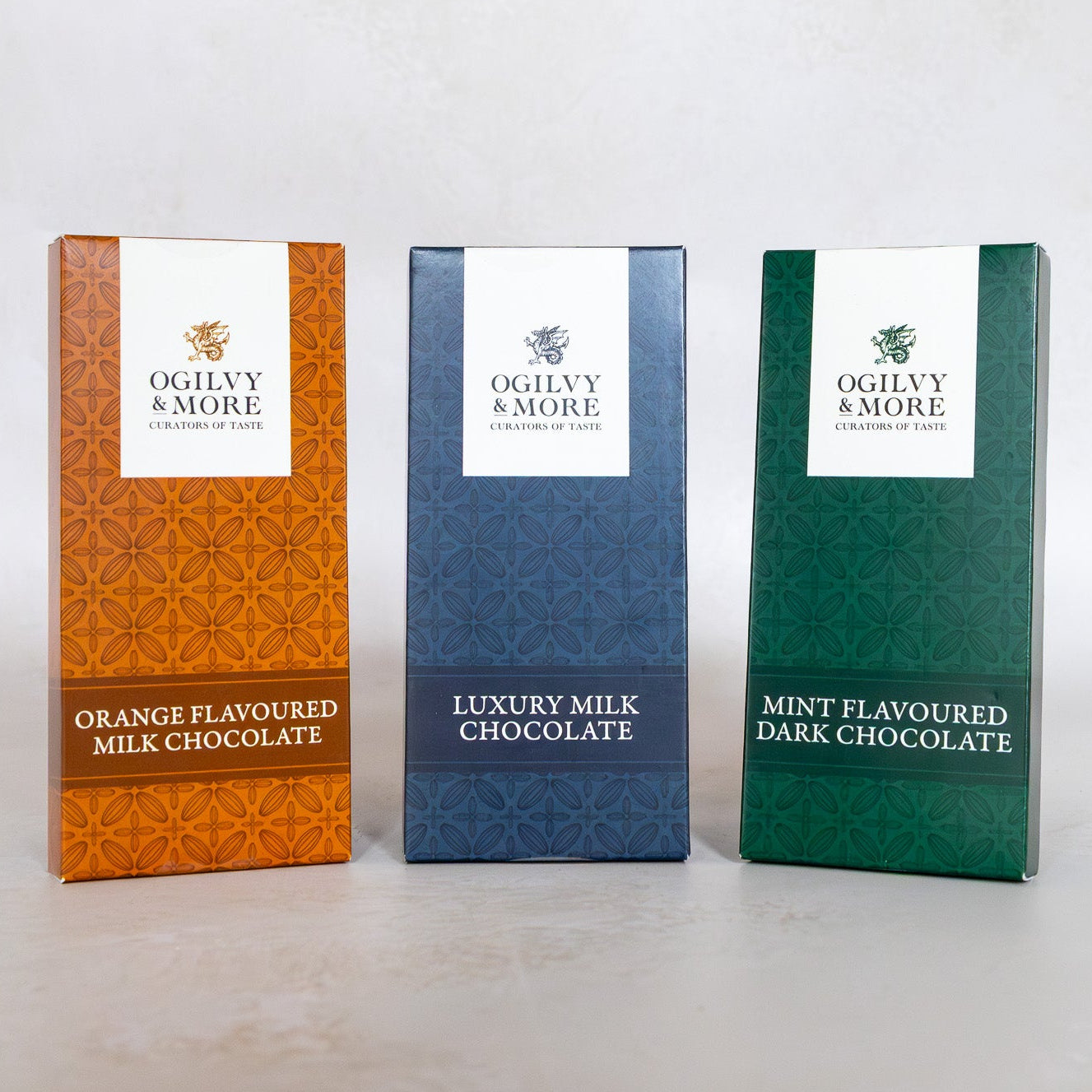 Three Ogilvy & More chocolate boxes with mint, milk, and orange on a white background