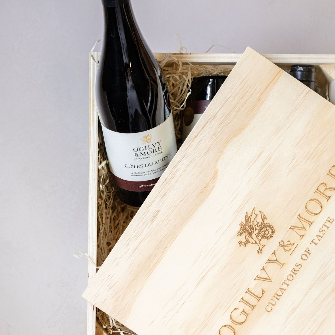 Cotes du rhone wine bottles in a wooden box with Oglivy & More branding.