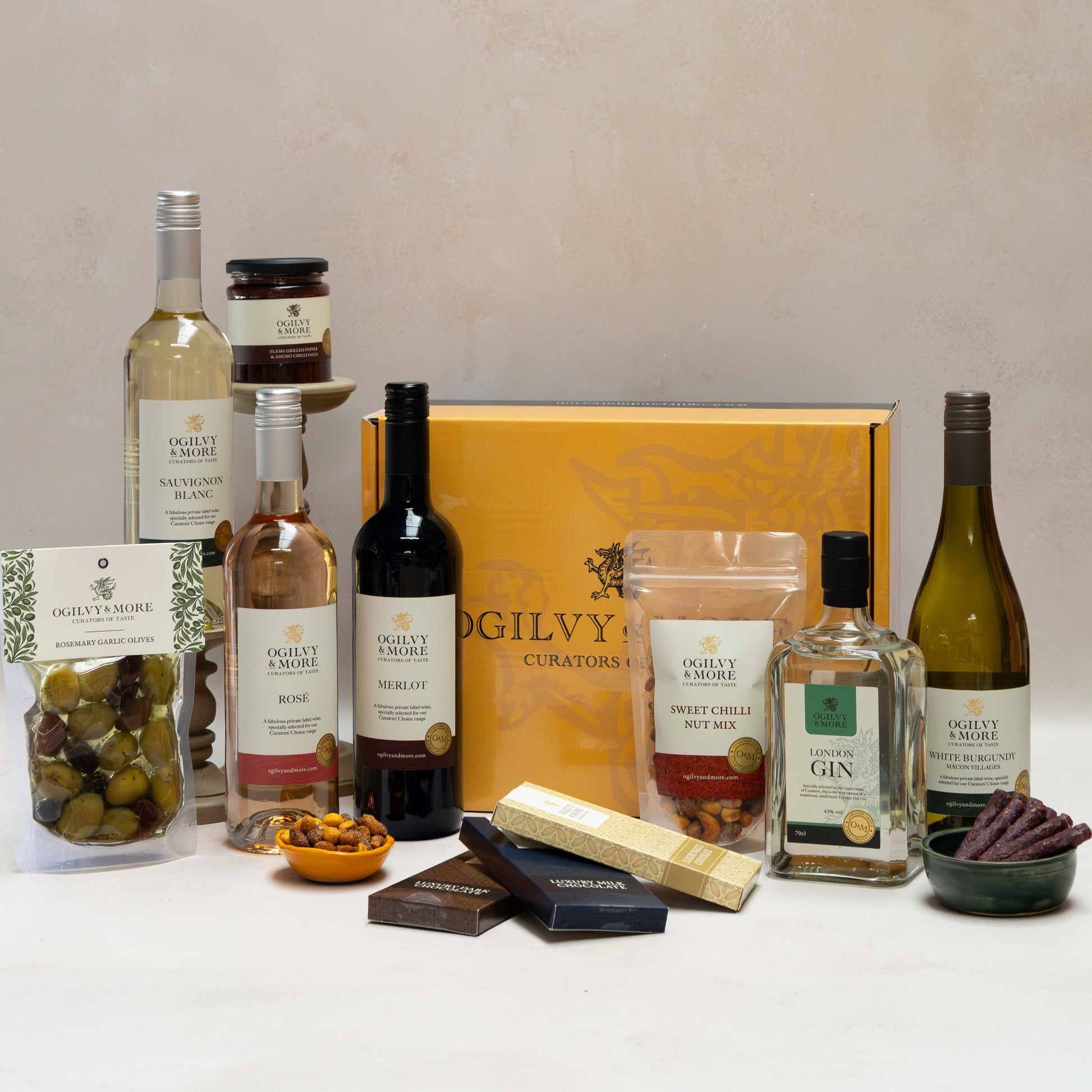 O&M Drinks and Nibbles Hamper on a white surface with a neutral background