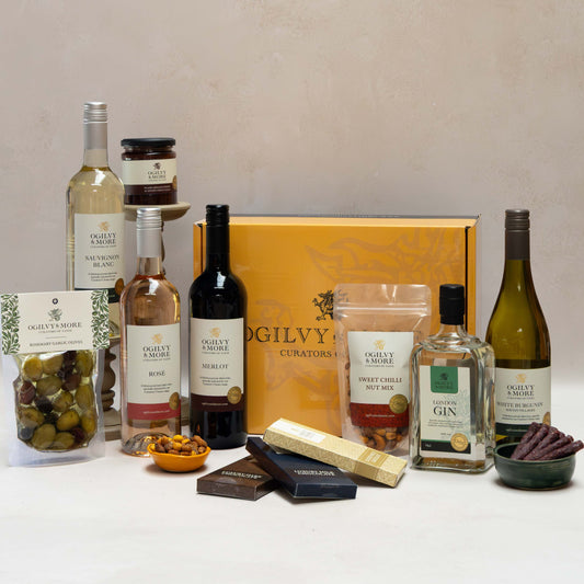 O&M Drinks and Nibbles Hamper on a white surface with a neutral background