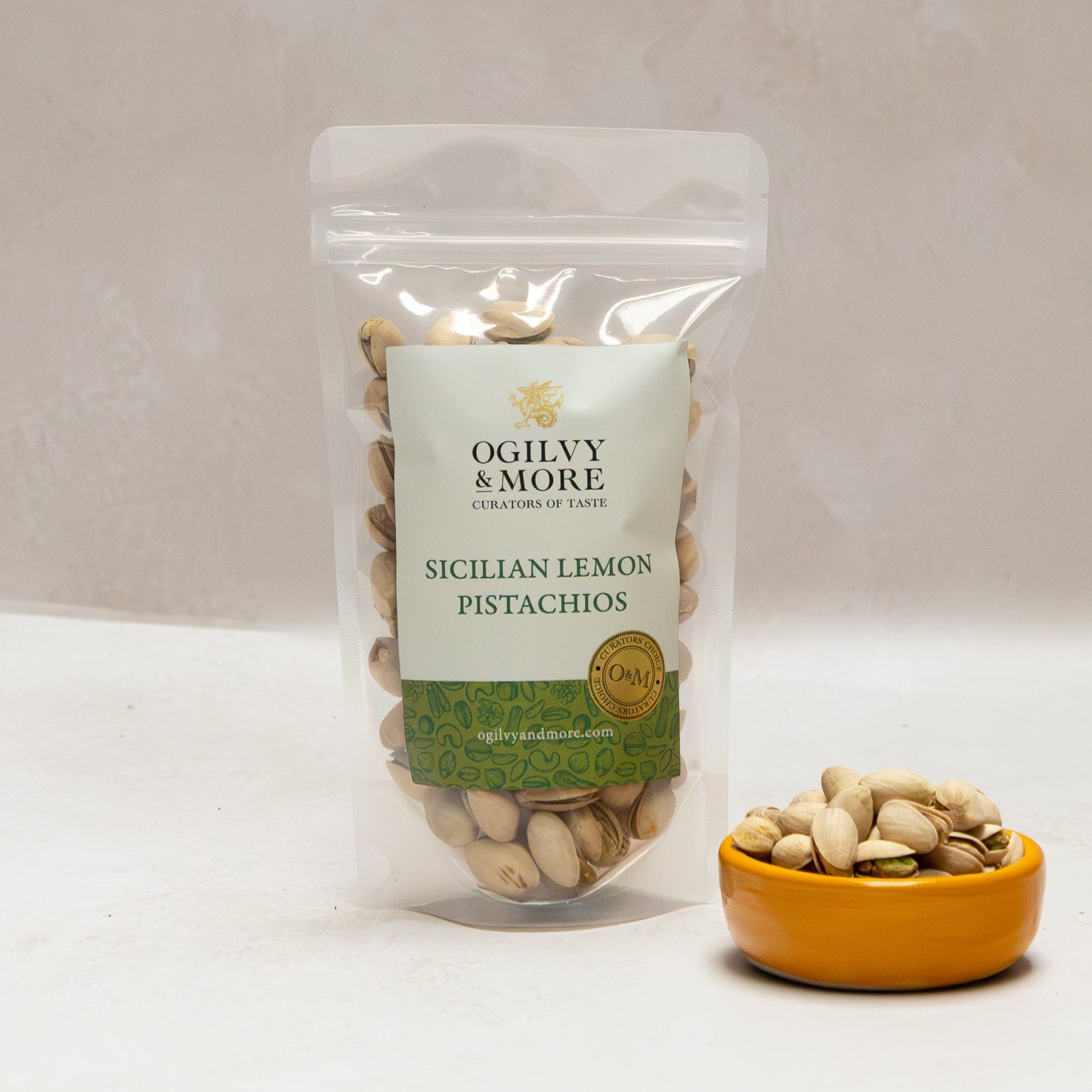 Ogilvy & More Sicilian Lemon Pistachios with a small bowl of pistachios on a light background