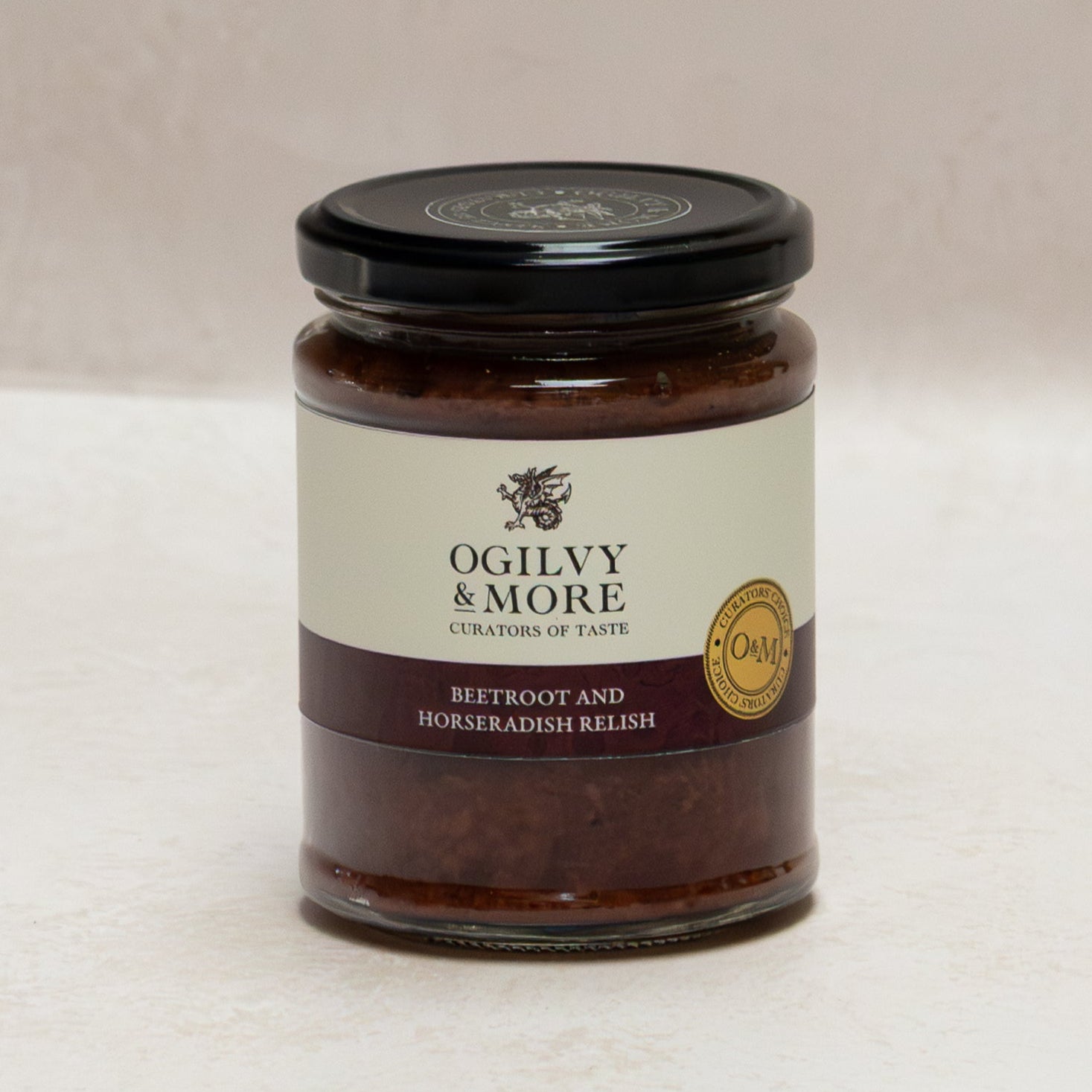 Jar of Oglivy & More beetroot and horseradish relish on a white surface with a beige background