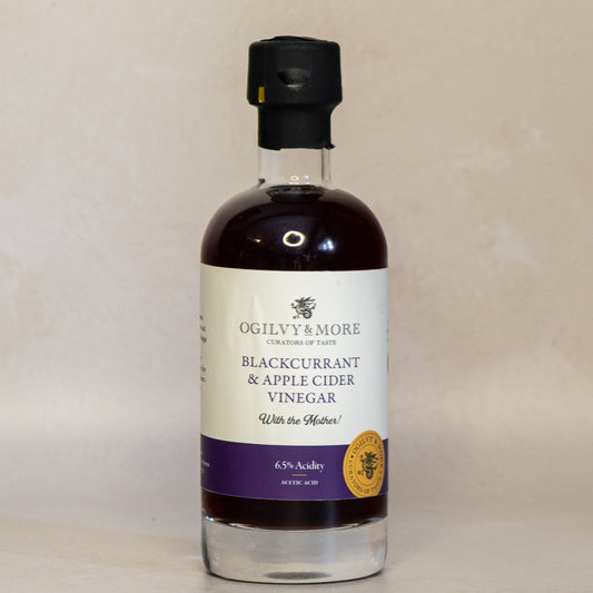 Bottle of Ogilvy & More Blackcurrant & Apple Cider Vinegar on a beige background