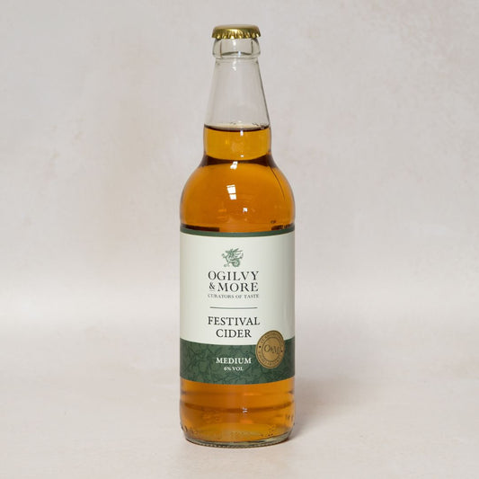 Bottle of Ogilvy & More Festival Cider on a white background
