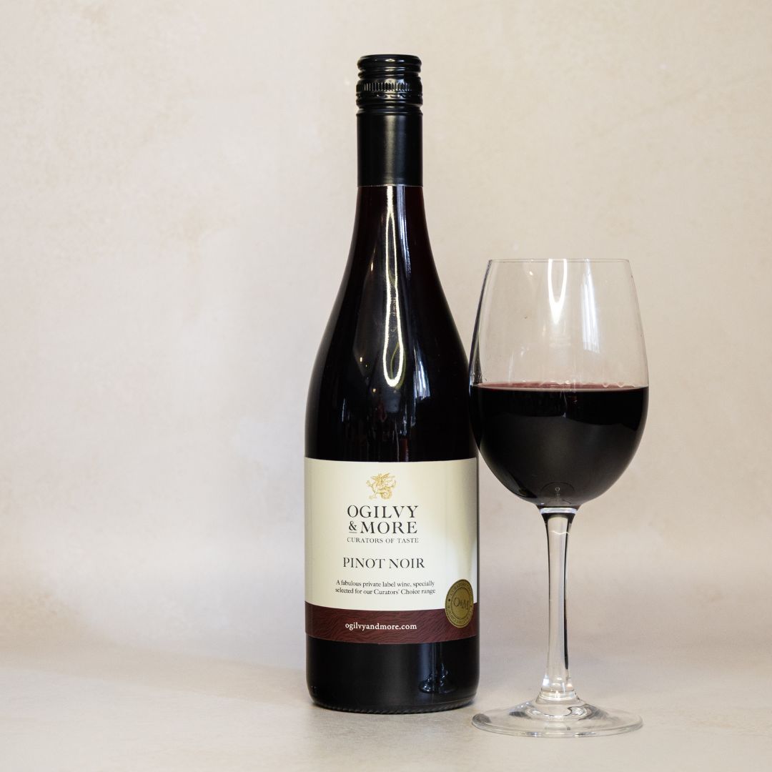 Ogilvy & More Pinot Noir wine bottle with a glass of red wine