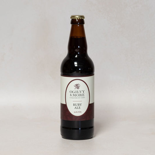 Bottle of Ogilvy & More Ruby Ale on a light gray background