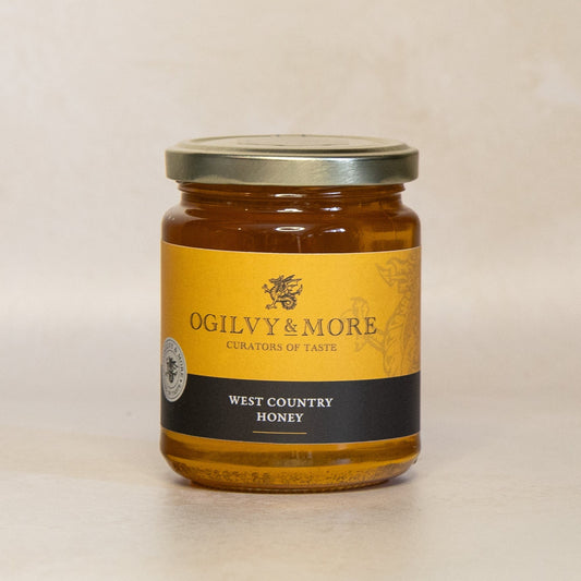 Jar of Ogilvy & More West Country Honey on a beige background