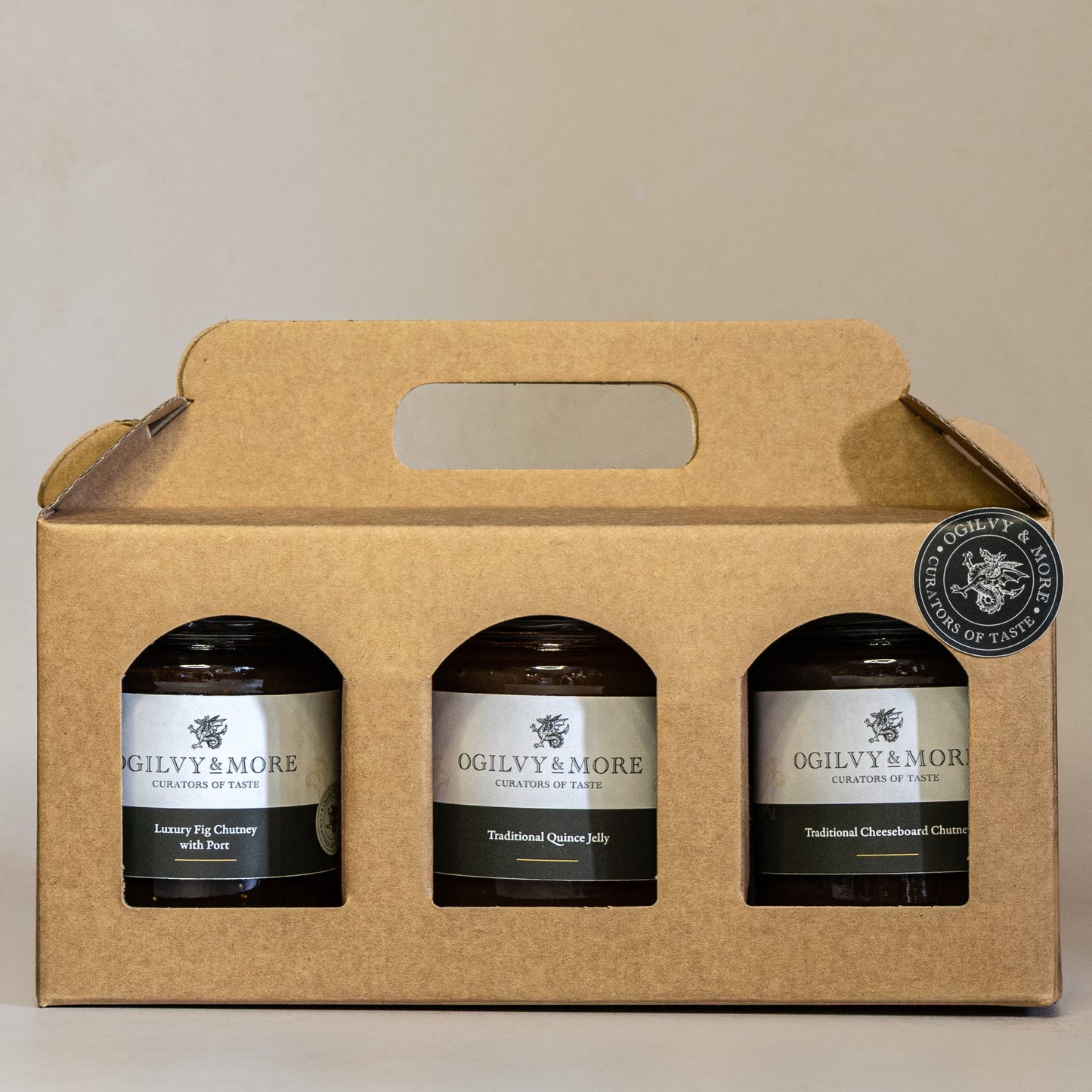 Three jars of Ogilvy & More chutney in a cardboard carrier on a beige background