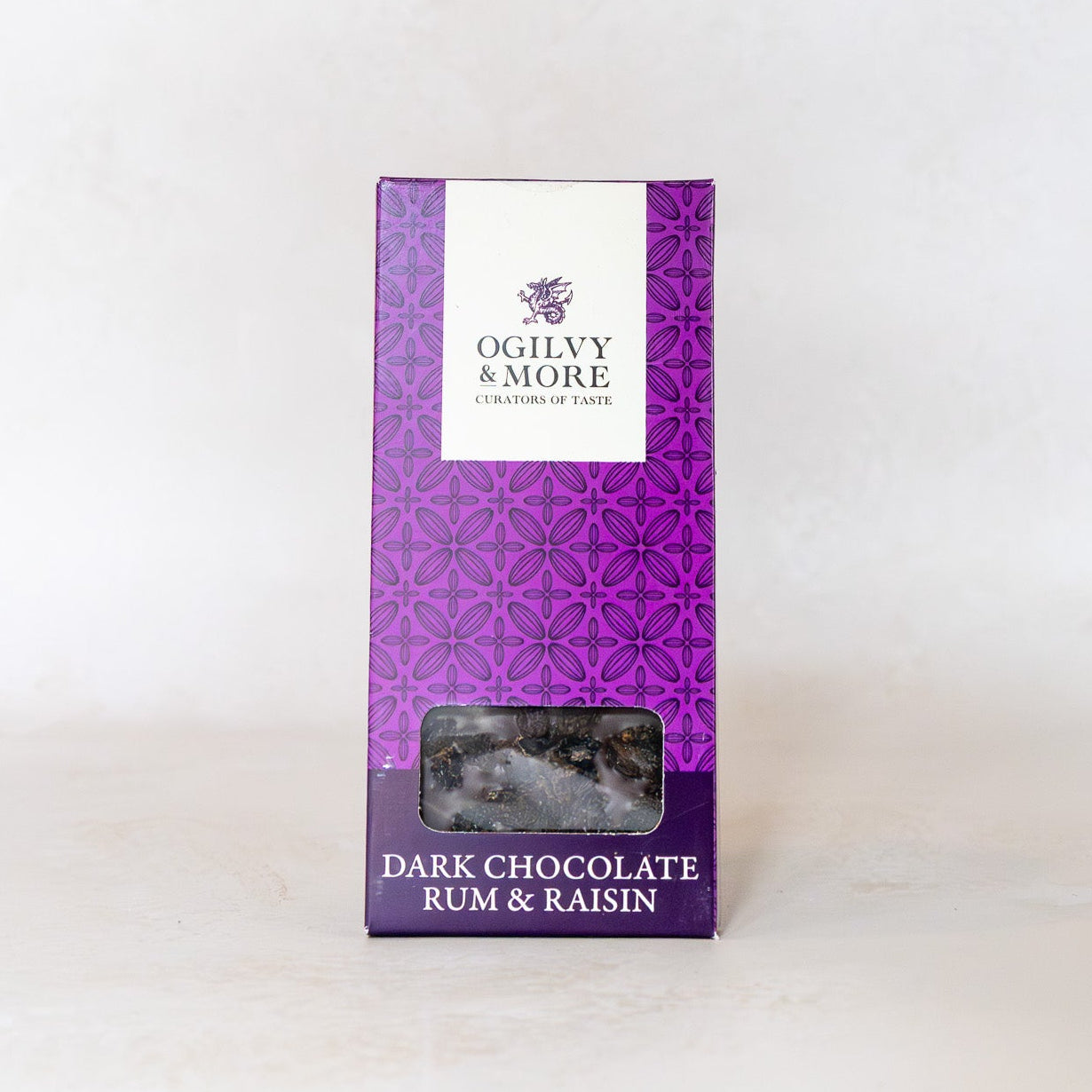 Purple packaging of Ogilvy & More dark chocolate rum & raisin on a white background