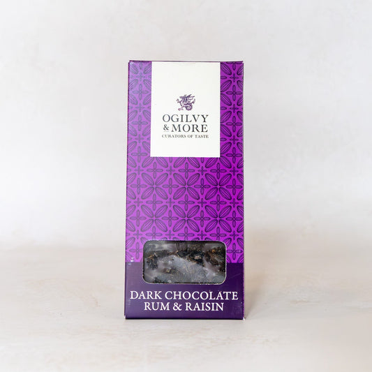 Purple packaging of Ogilvy & More dark chocolate rum & raisin on a white background