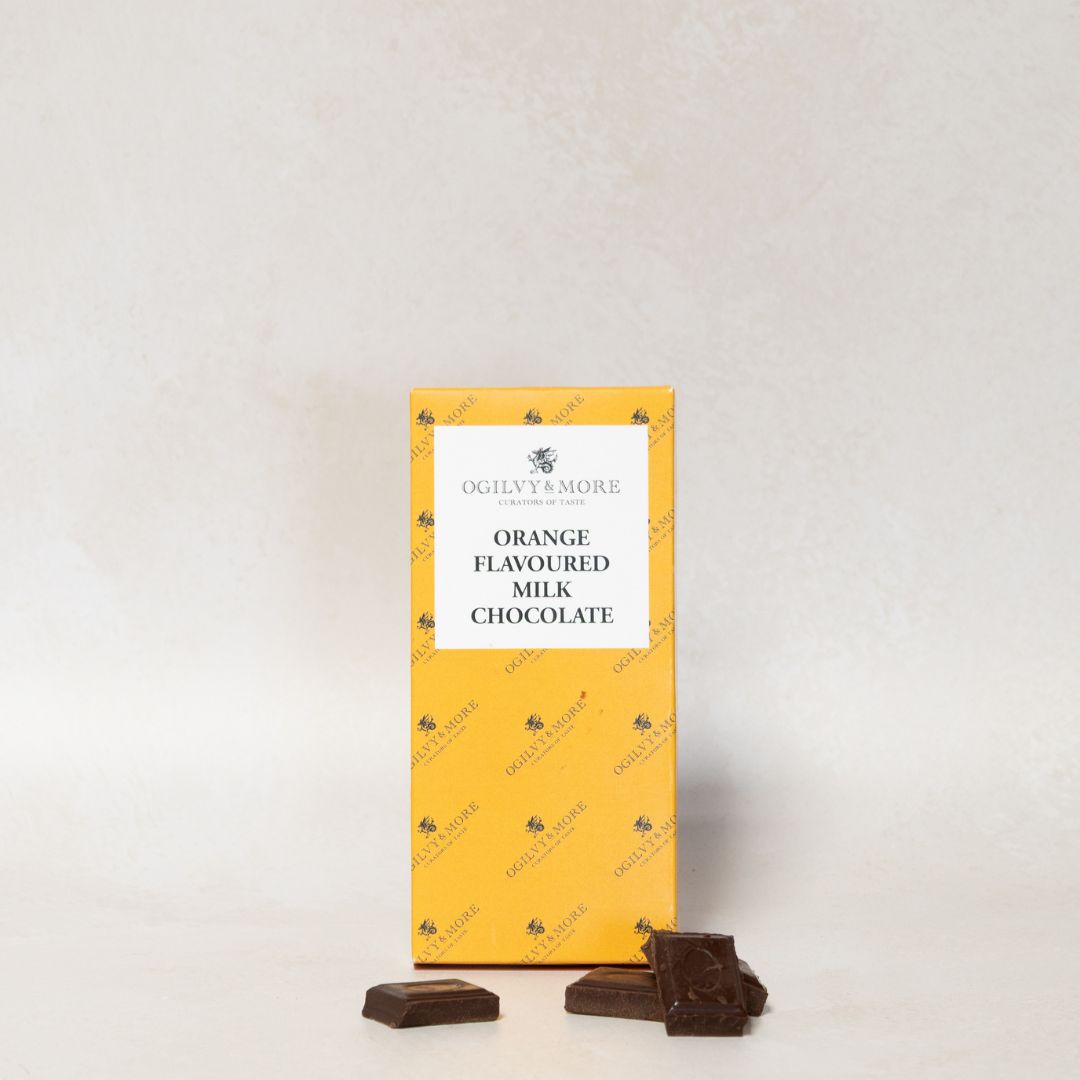Packet of Ogilvy & More orange-flavoured milk chocolate with two pieces on a light gray background
