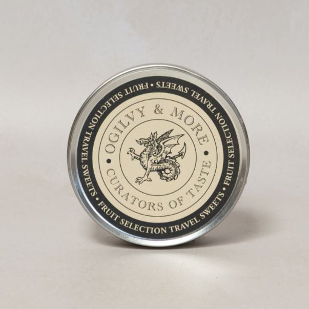 Round Ogilvy & More travel sweets container with a label on a light gray background