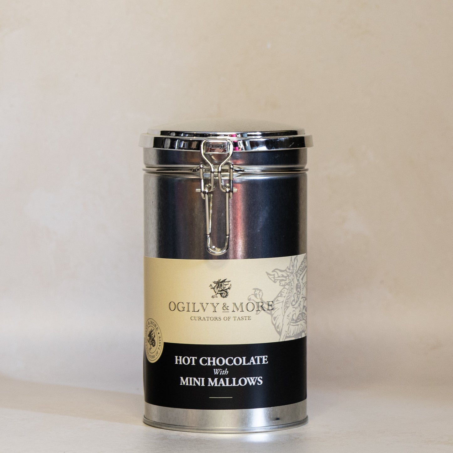 Canister of Ogilvy and More hot chocolate with mini marshmallows on a beige background