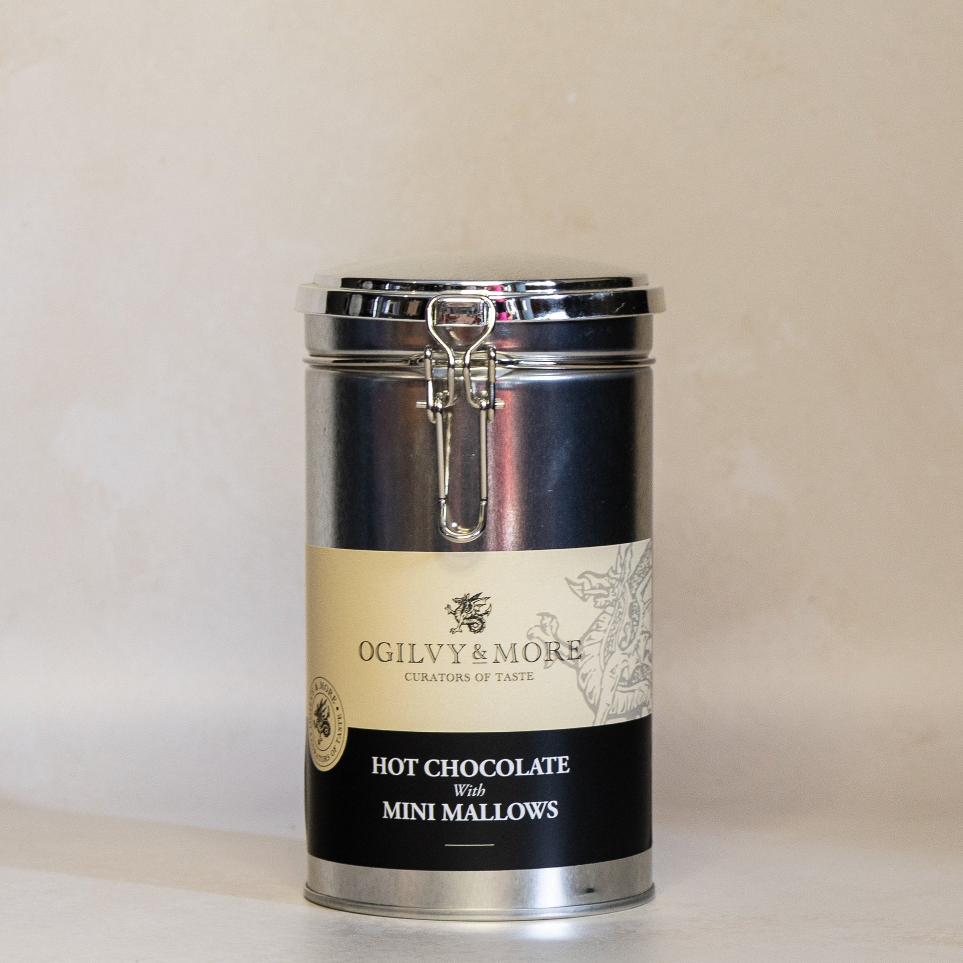 Canister of Ogilvy and More hot chocolate with mini marshmallows on a beige background