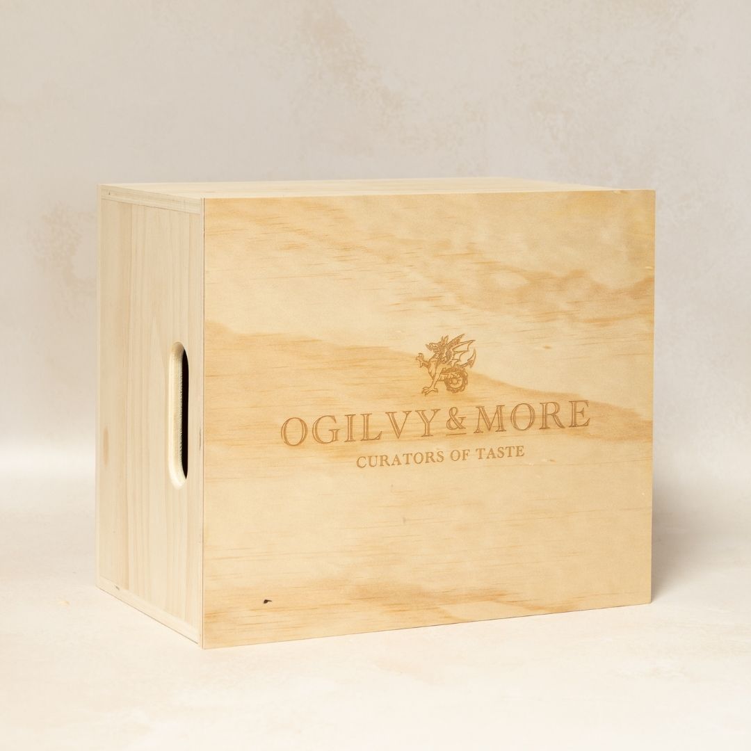 Wooden box with 'Ogilvy & More' branding on a light background