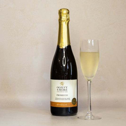 Bottle of Ogilvy & More Prosecco with a glass