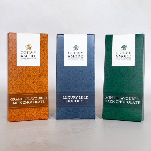 Three Ogilvy & More chocolate boxes with mint, milk, and orange on a white background