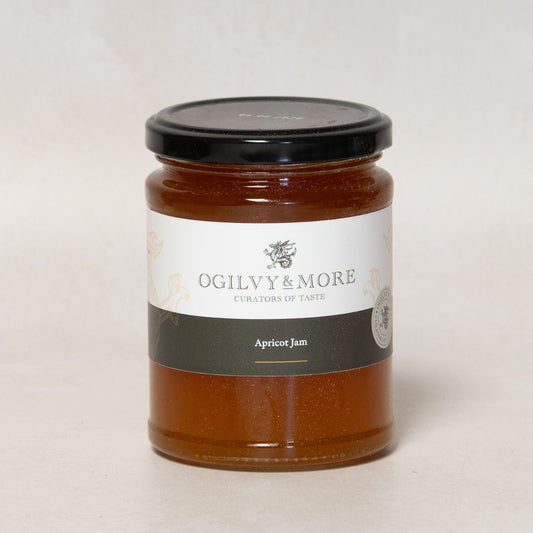 Jar of apricot jam with 'Ogilvy & More' label on a light background