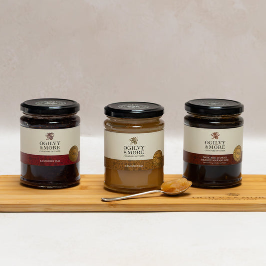 Three jars of Ogilvy &More Jam on a wooden board with a white background