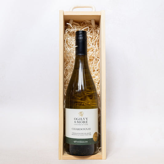 Ogilvy & More Chardonnay wine bottle in a wooden box on a white background