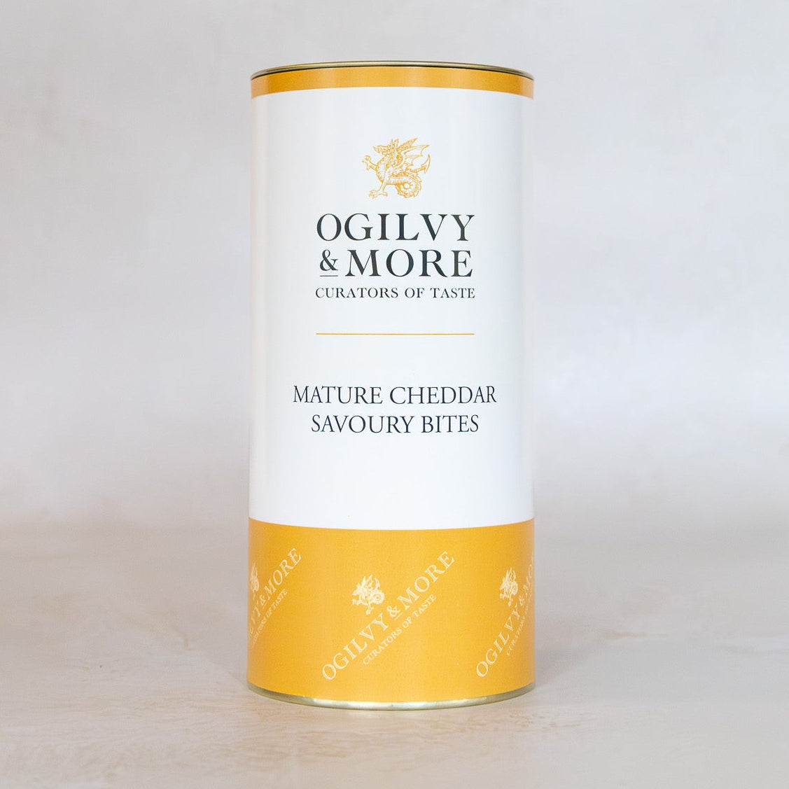 Tube of Ogilvy & More Mature Cheddar Savoury Bites on a light gray background