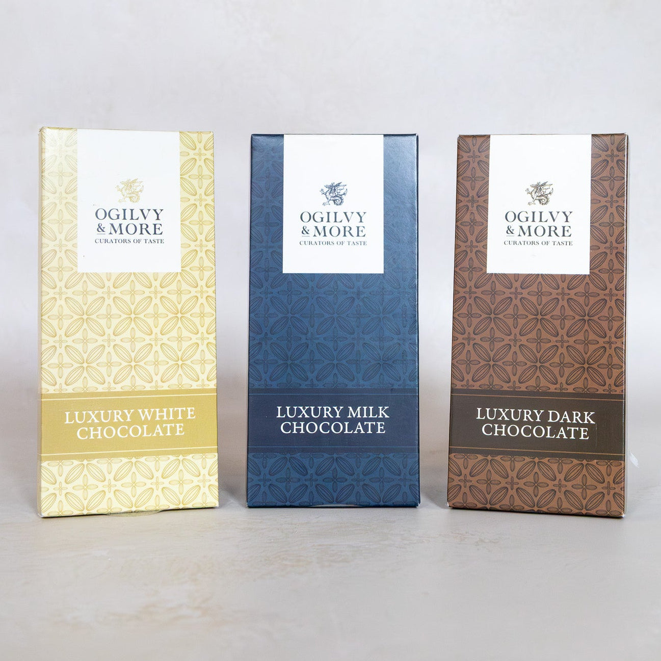 Three chocolate boxes labeled 'Luxury White Chocolate', 'Luxury Milk Chocolate', and 'Luxury Dark Chocolate' on a light gray background.