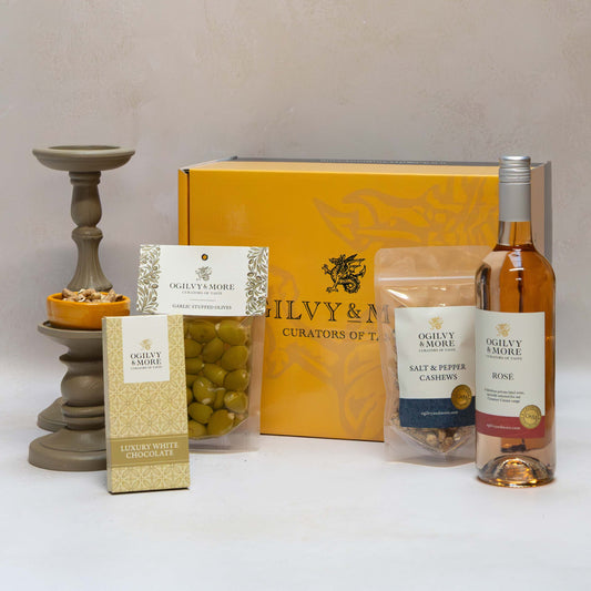 Ogilvy & More Light & Lovely Gift set with a box, bottle, and various items on a white surface.
