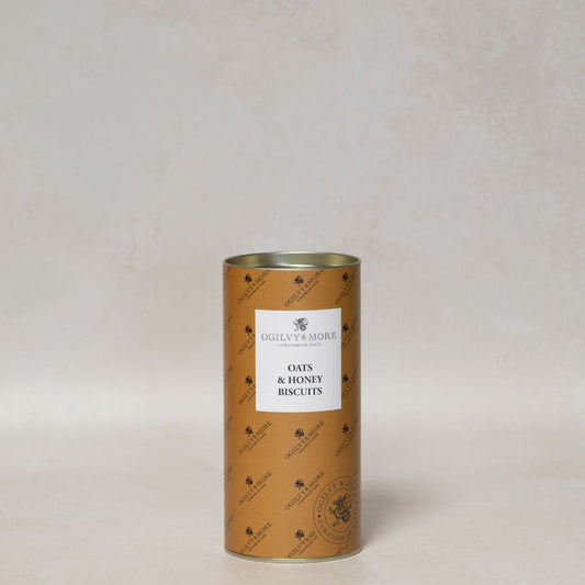 Canister of Ogilvy & More Oats & Honey Biscuits with a label on a light gray background