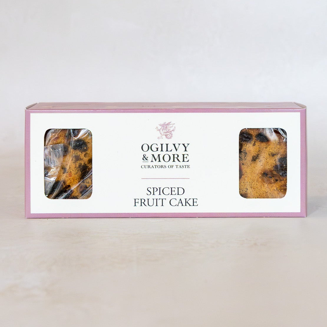 Ogilvy & More Spiced Fruit Cake packaging on a gradient background
