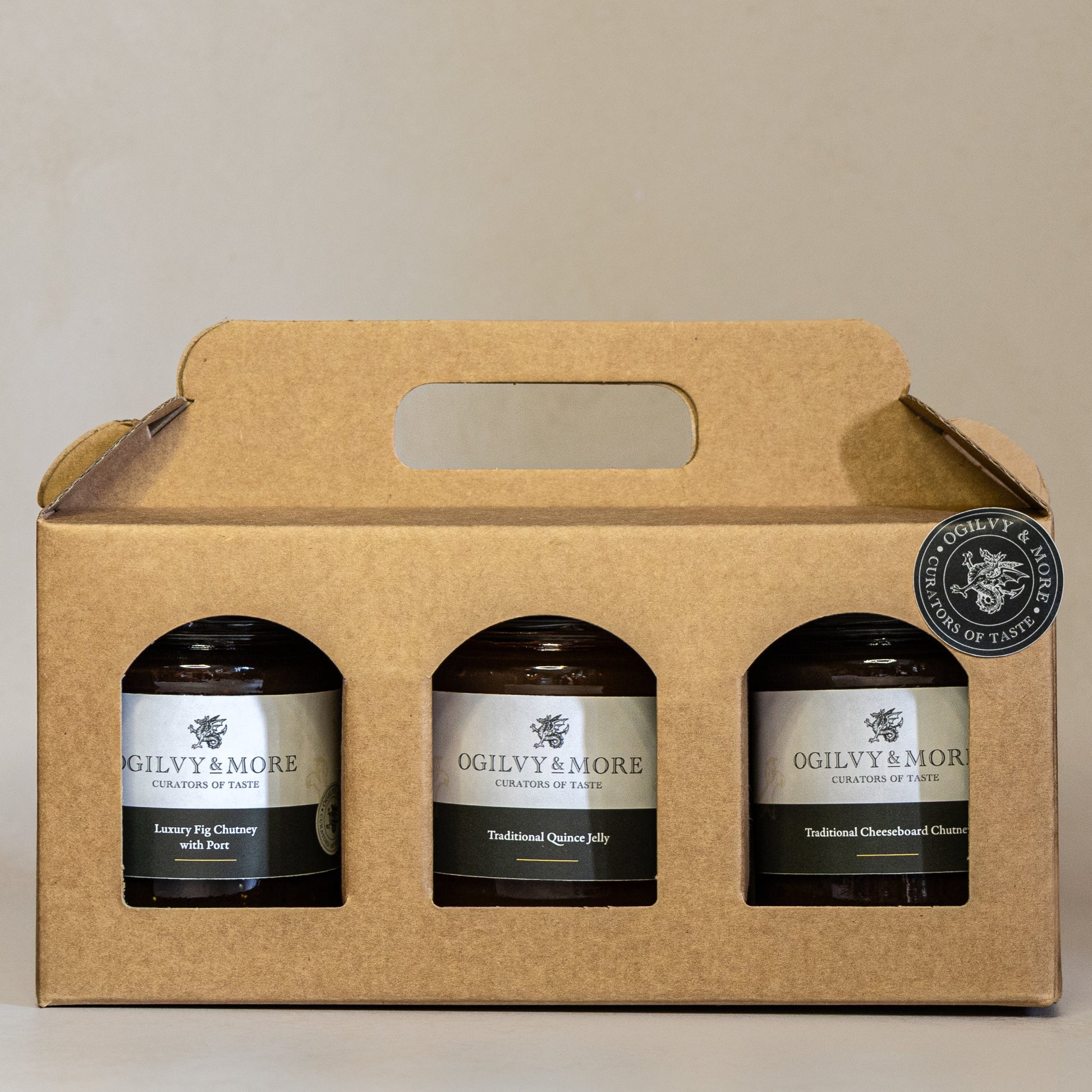 Three jars of Ogilvy & More chutney in a cardboard carrier on a beige background