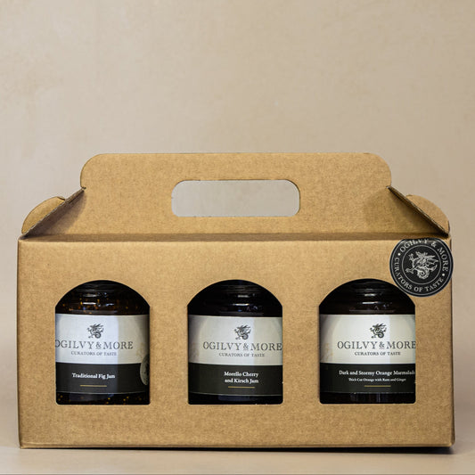 Three jars in a cardboard gift box with Ogilvy & More jam and chutney on a beige background