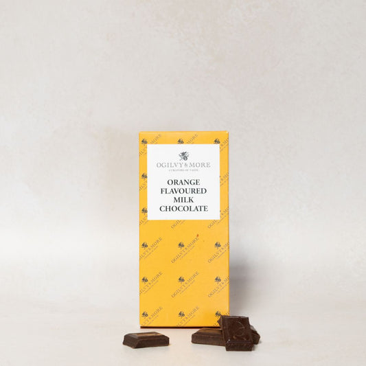 Packet of Ogilvy & More orange-flavoured milk chocolate with two pieces on a light gray background