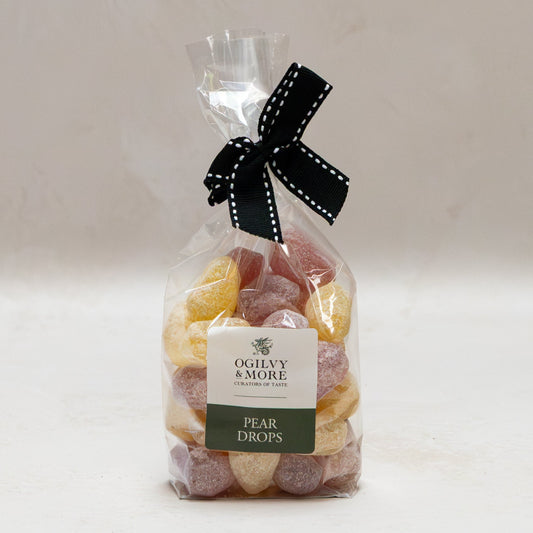 Bag of Ogilvy & More pear drops with a black ribbon on a white background