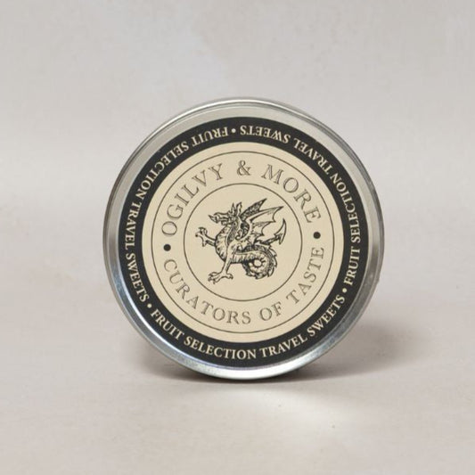 Round Ogilvy & More travel sweets container with a label on a light gray background