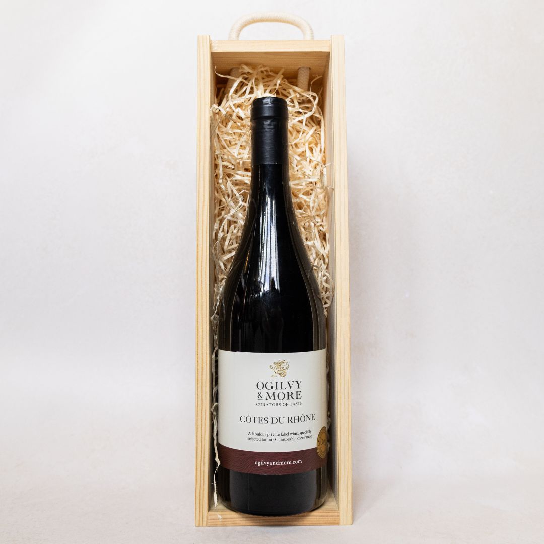 Ogilvy and More Cotes du Rhone bottle in a wooden box on a white background