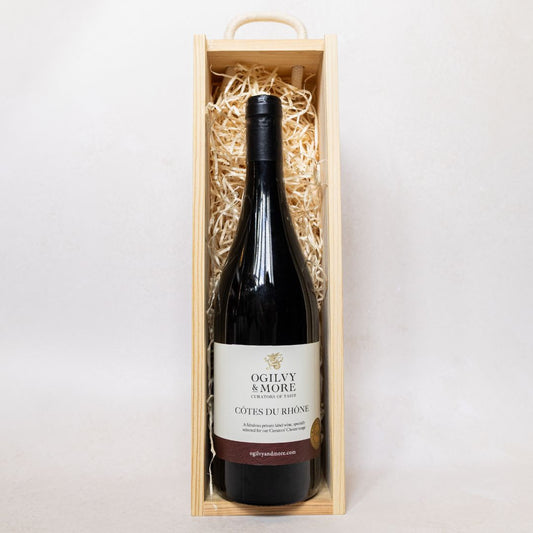 Ogilvy and More Cotes du Rhone bottle in a wooden box on a white background