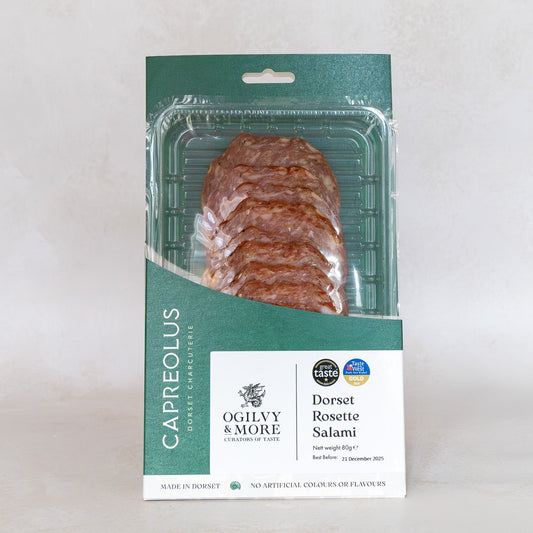 Packaged dorset rosette salami with a green and white label on a light gray background